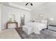 Light filled bedroom with ceiling fan, console table, and ensuite bathroom at 427 Bluffberry Way, Hillsborough, NC 27278