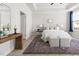 Airy bedroom with woven console table and mirror in an elegant, neutral palette at 427 Bluffberry Way, Hillsborough, NC 27278