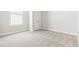 Well-lit bedroom featuring neutral carpet, double door closet, and a window at 427 Bluffberry Way, Hillsborough, NC 27278