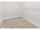 Empty walk in closet with neutral carpet and trim awaiting organization at 427 Bluffberry Way, Hillsborough, NC 27278