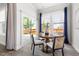 Cozy dining area with a round table and view of the backyard through sliding glass doors at 427 Bluffberry Way, Hillsborough, NC 27278