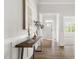 Inviting entryway with hardwood floors, stylish console table, and clear view of the front door with sidelights at 427 Bluffberry Way, Hillsborough, NC 27278