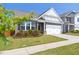 Charming home with a two-car garage, well-manicured lawn, and beautiful landscaping around the front window at 427 Bluffberry Way, Hillsborough, NC 27278