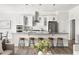 Modern kitchen features a large island with seating, stainless steel appliances and pendant lighting at 427 Bluffberry Way, Hillsborough, NC 27278