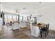 Open-concept living room with a view of the kitchen and dining area, featuring lots of natural light at 427 Bluffberry Way, Hillsborough, NC 27278