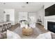 Spacious living room with hardwood floors, a fireplace, a large rug, and comfortable seating areas at 427 Bluffberry Way, Hillsborough, NC 27278