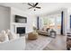 Bright and inviting living room with a fireplace, large windows, and comfortable seating area on a decorative rug at 427 Bluffberry Way, Hillsborough, NC 27278