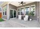 Covered patio featuring neutral siding, ceiling fan, and white patio furniture at 427 Bluffberry Way, Hillsborough, NC 27278