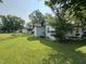 View of a house's backyard featuring a green lawn, a white painted exterior, and surrounding shrubbery at 429 5Th & Brogden Rd, Smithfield, NC 27577