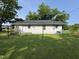 The backyard features a grassy yard with a cinder block home and mature trees at 429 5Th & Brogden Rd, Smithfield, NC 27577