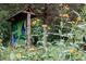 A beautiful trailside painted sign surrounded by bright yellow flowering plants at 4821 Gossamer Ln # 103, Raleigh, NC 27616