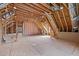Unfinished attic space with exposed beams and natural light ready to be transformed at 4913 Great Meadows Ct, Raleigh, NC 27609