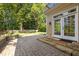 Stone patio and step-down landing lead to a bright backyard at 4913 Great Meadows Ct, Raleigh, NC 27609