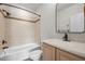 Cozy bathroom featuring a tub with tile surround and updated vanity at 4913 Great Meadows Ct, Raleigh, NC 27609