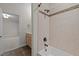 Bathroom featuring granite vanity, decorative tile border in tub/shower, and access door to another room at 4913 Great Meadows Ct, Raleigh, NC 27609
