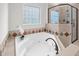Bright bathroom with large tub, tile accents, and glass block window at 4913 Great Meadows Ct, Raleigh, NC 27609