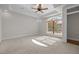 Bright, airy bedroom featuring a large window, tray ceilings, and neutral carpeting at 4913 Great Meadows Ct, Raleigh, NC 27609