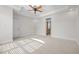 Spacious bedroom featuring a tray ceiling with fan and walk-in closet at 4913 Great Meadows Ct, Raleigh, NC 27609