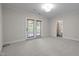 Spacious bedroom featuring neutral carpet, natural light, and access to a balcony and bathroom at 4913 Great Meadows Ct, Raleigh, NC 27609