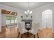 Dining room features stone fireplace, hardwood floors and access to the sunroom at 4913 Great Meadows Ct, Raleigh, NC 27609