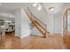Inviting foyer features hardwood floors and a staircase with decorative iron spindles and a view into the dining room at 4913 Great Meadows Ct, Raleigh, NC 27609