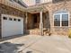 Inviting front entrance showcasing stone accents, a covered porch, and an attached two-car garage at 4913 Great Meadows Ct, Raleigh, NC 27609