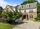 Charming exterior of a stone and siding home featuring an attached two-car garage, manicured lawn and inviting front entrance at 4913 Great Meadows Ct, Raleigh, NC 27609