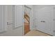Hallway featuring hardwood floors and trim with a view of the staircase and nearby closet at 4913 Great Meadows Ct, Raleigh, NC 27609