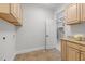 Functional laundry room featuring cabinetry and tile flooring at 4913 Great Meadows Ct, Raleigh, NC 27609