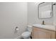 Powder room features a granite vanity, decorative mirror, and toilet at 4913 Great Meadows Ct, Raleigh, NC 27609