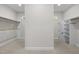 Large walk-in closet with neutral carpet and custom shelving at 4913 Great Meadows Ct, Raleigh, NC 27609