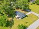Aerial view of home featuring long driveway, manicured lawn, garden area, and a new roof at 492 N Dunn St, Angier, NC 27501
