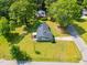 Overhead view of well-maintained property with manicured lawn, mature trees, and asphalt shingle roof at 492 N Dunn St, Angier, NC 27501