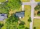 Aerial shot showcasing the home with a long driveway, mature trees, garden area, and new roof at 492 N Dunn St, Angier, NC 27501