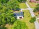 Aerial view of property featuring long driveway, mature trees, garden area, and a new roof at 492 N Dunn St, Angier, NC 27501