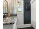 Bathroom featuring a marble vanity top, black accent wall, and shower with white subway tile and a window at 492 N Dunn St, Angier, NC 27501
