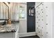Bathroom with shower and vanity with granite countertop and black hardware at 492 N Dunn St, Angier, NC 27501