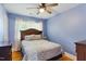 Bedroom with hardwood floors, ceiling fan, and natural light from a bright window at 492 N Dunn St, Angier, NC 27501