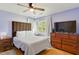 Bedroom with hardwood floors, ceiling fan, and natural light from a bright window at 492 N Dunn St, Angier, NC 27501