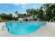 A large community pool is surrounded by lounge chairs and lush landscaping on a sunny day at 492 N Dunn St, Angier, NC 27501