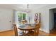 Inviting dining area with a round table and natural light streaming through the windows at 492 N Dunn St, Angier, NC 27501
