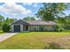 Charming single-story home with a manicured lawn, a garage, and beautiful landscaping at 492 N Dunn St, Angier, NC 27501