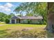 Traditional home boasts an attached garage, a well-kept lawn, and mature trees enhancing its curb appeal at 492 N Dunn St, Angier, NC 27501