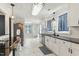 Bright kitchen features white cabinets, black countertops, stainless steel appliances, and tile flooring at 492 N Dunn St, Angier, NC 27501