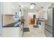 Modern kitchen with white cabinets, stainless steel appliances, and marble tile floors at 492 N Dunn St, Angier, NC 27501