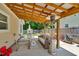 Inviting back patio with a seating area, charming pergola, and a well-manicured fenced yard at 512 Wyndham Dr, Fuquay Varina, NC 27526