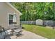 Spacious backyard with a patio, green lawn, shed, and a beautiful garden bed at 512 Wyndham Dr, Fuquay Varina, NC 27526