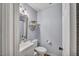 Inviting bathroom featuring soft lighting, a decorative wall shelf, and a modern vanity at 512 Wyndham Dr, Fuquay Varina, NC 27526