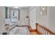 Bedroom with wood floors, a wooden bench and an armchair at 512 Wyndham Dr, Fuquay Varina, NC 27526