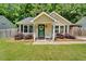 Charming single-story home featuring a cozy front porch and lush, well-maintained landscaping at 512 Wyndham Dr, Fuquay Varina, NC 27526